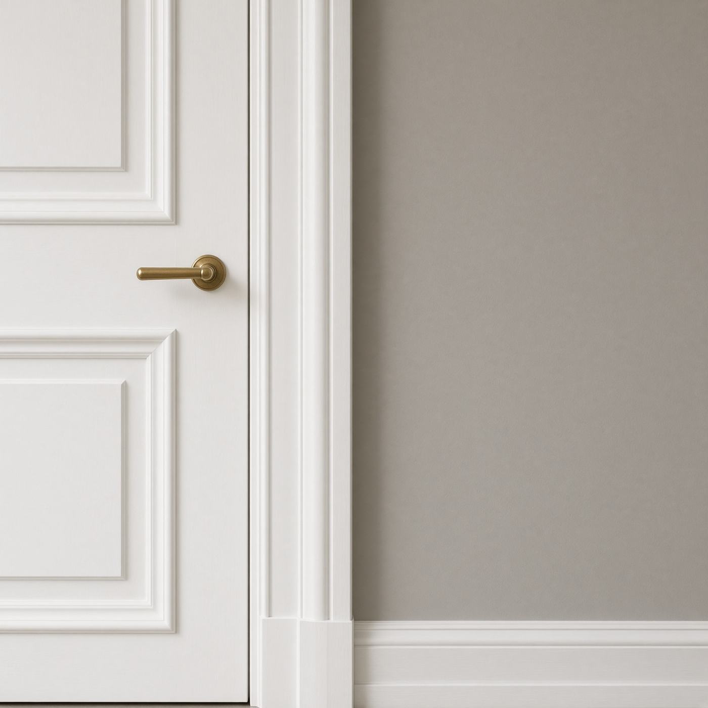 Freshly painted white interior doors and architraves against a grey wall